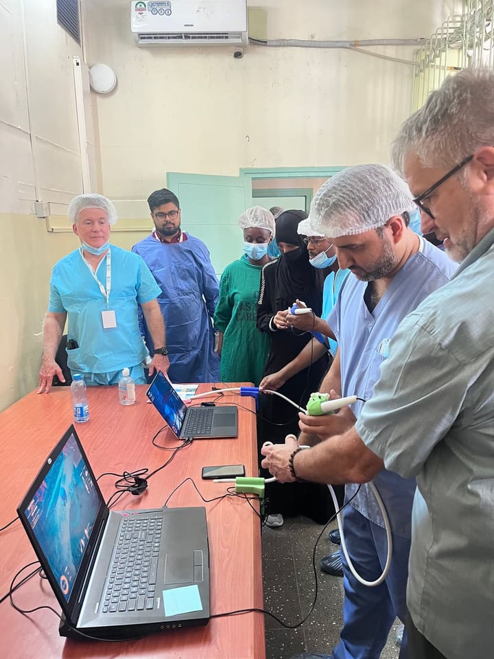 Participants working together with surgical simulation equipment
