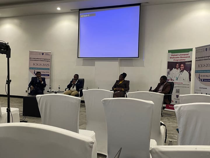 Panel participants seated at the front of a congress meeting room