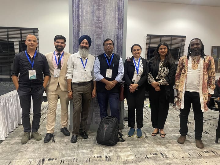 Seven congress participants posing together indoors