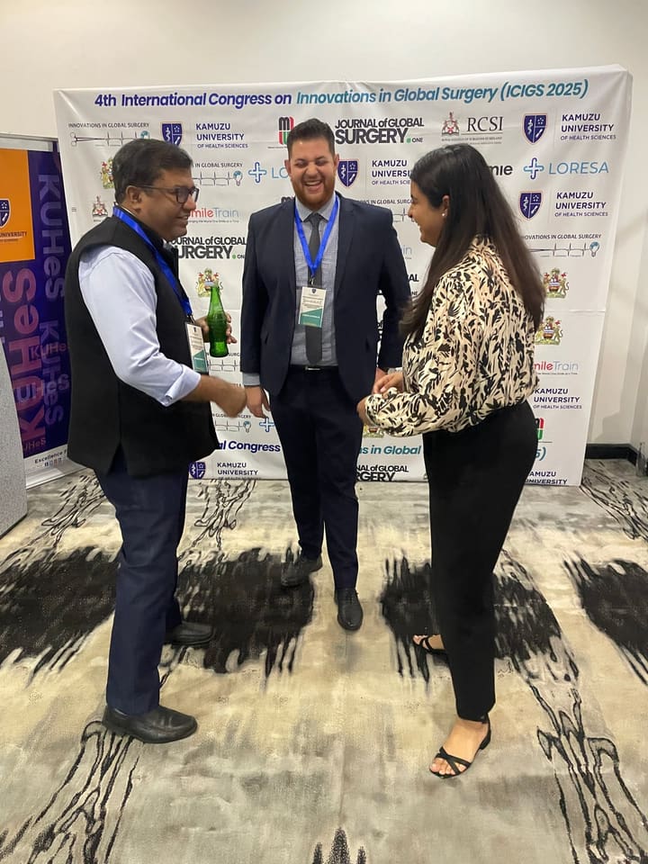 Three delegates exchanging greetings at the congress