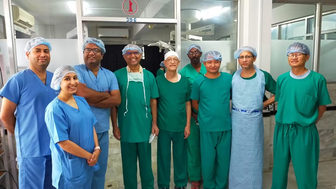 IGS colleagues gathered in a surgical setting