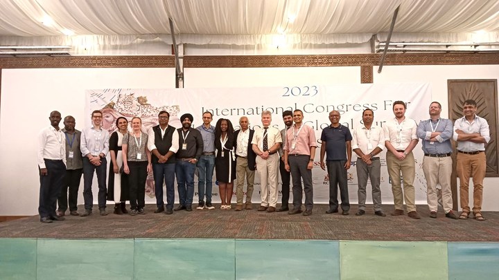 ICIGS 2023 participants standing together on stage in Kenya